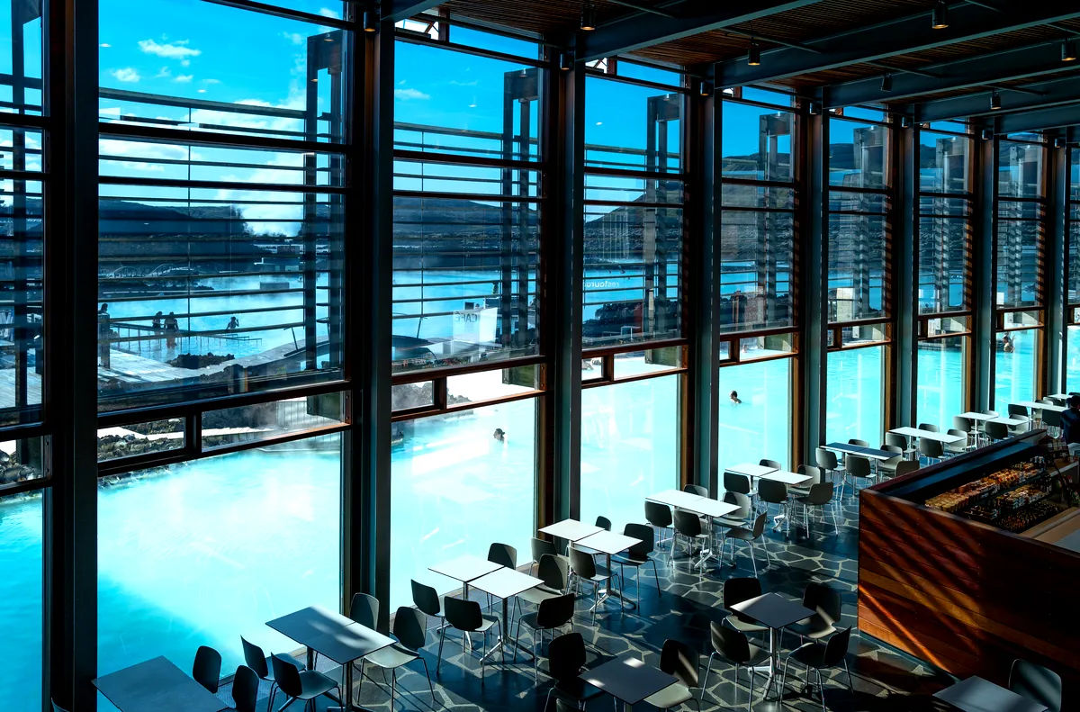 Interior of the Blue Lagoon restaurant, with large windows offering a view of the steaming geothermal pools.