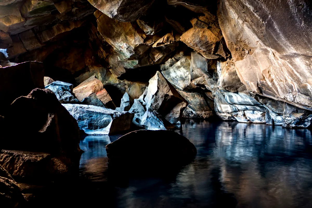 Inside view of Grjótagjá Cave, with hot geothermal water and stunning rock formations, a hidden Icelandic treasure