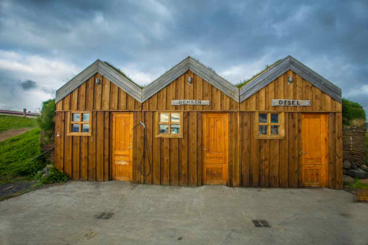 Wooden fuel station in Iceland with separate doors for gasoline and diesel.