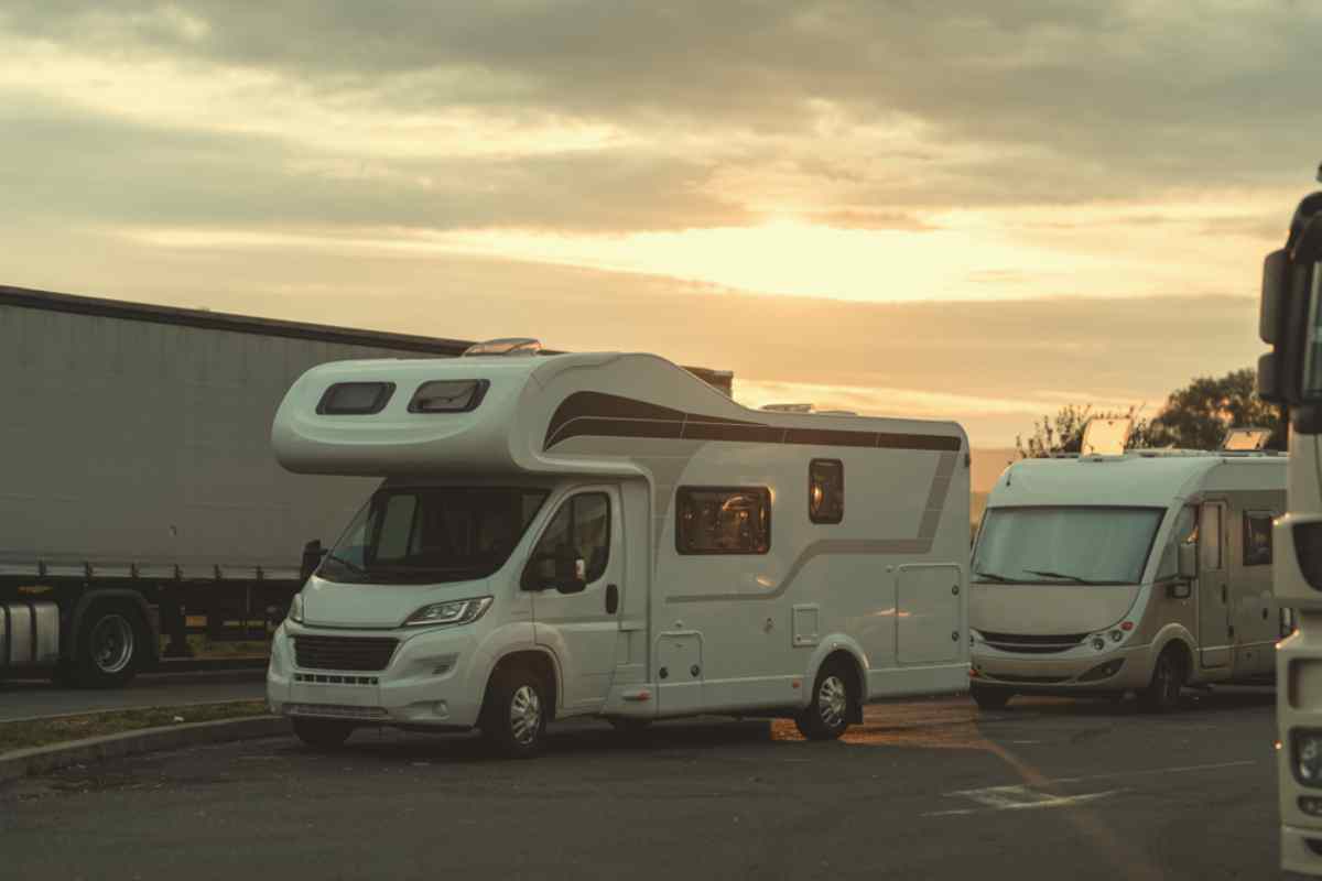Motorhome parked at a gas station in Iceland during sunset.