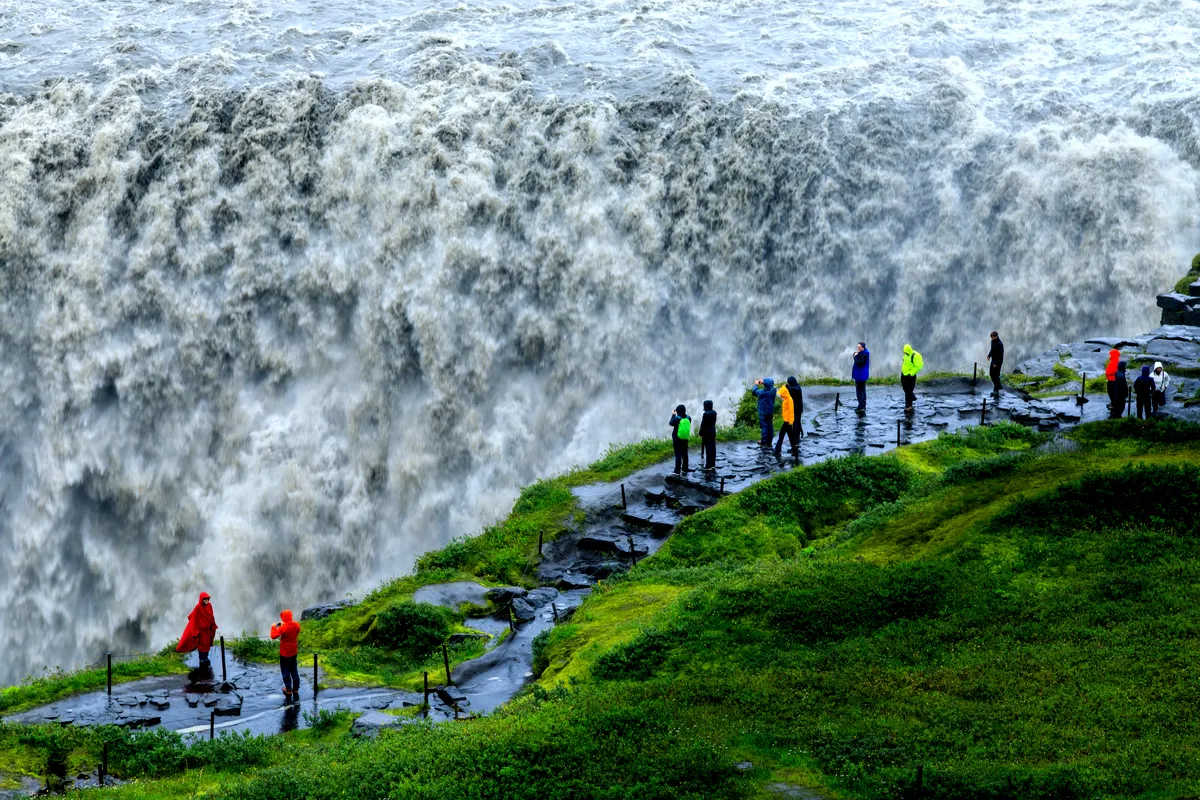 Visitors standing near the powerful Dettifoss waterfall in Iceland, known as one of Europe&rsquo;s most forceful waterfalls