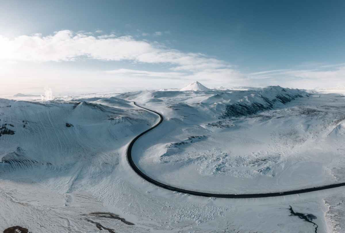Winding road through a landscape completely covered with snow