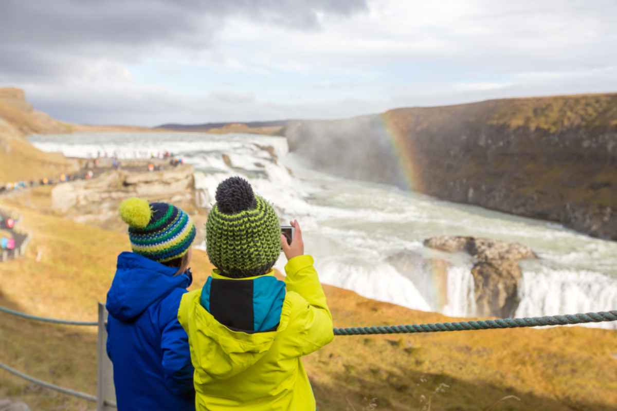 A couple of children enjoy the spectacle of nature at Iceland's Gullfoss waterfall.
