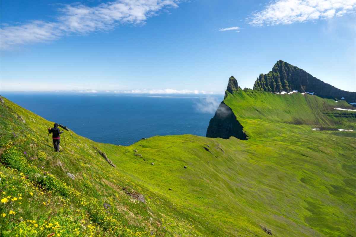 Hiker walking through the impressive landscape of Hornstrandir