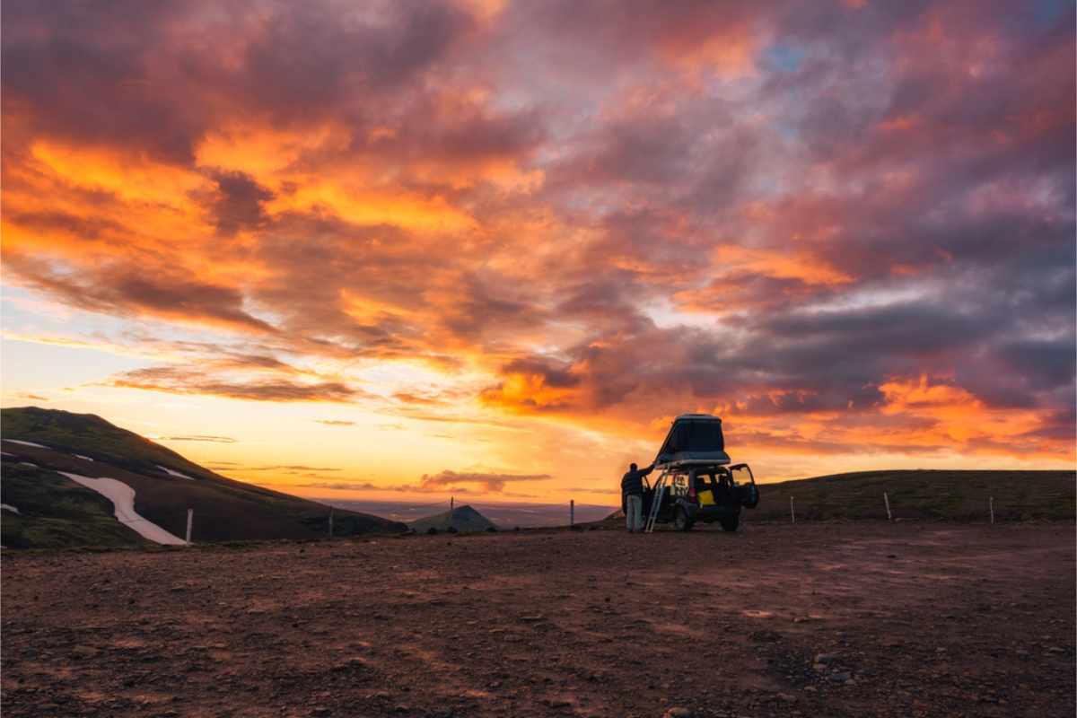 4x4 rooftop tent camper under a redish cloudy sky