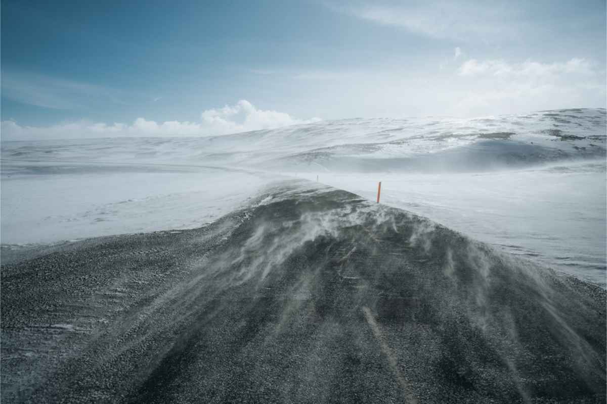 Wind blowing snow onto the road in Iceland