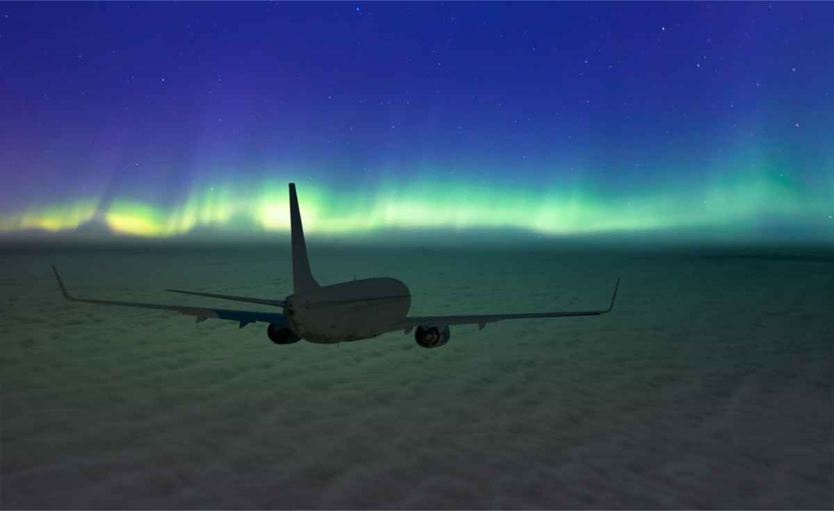 Aircraft heading to Iceland with the Northern Light on the horizon