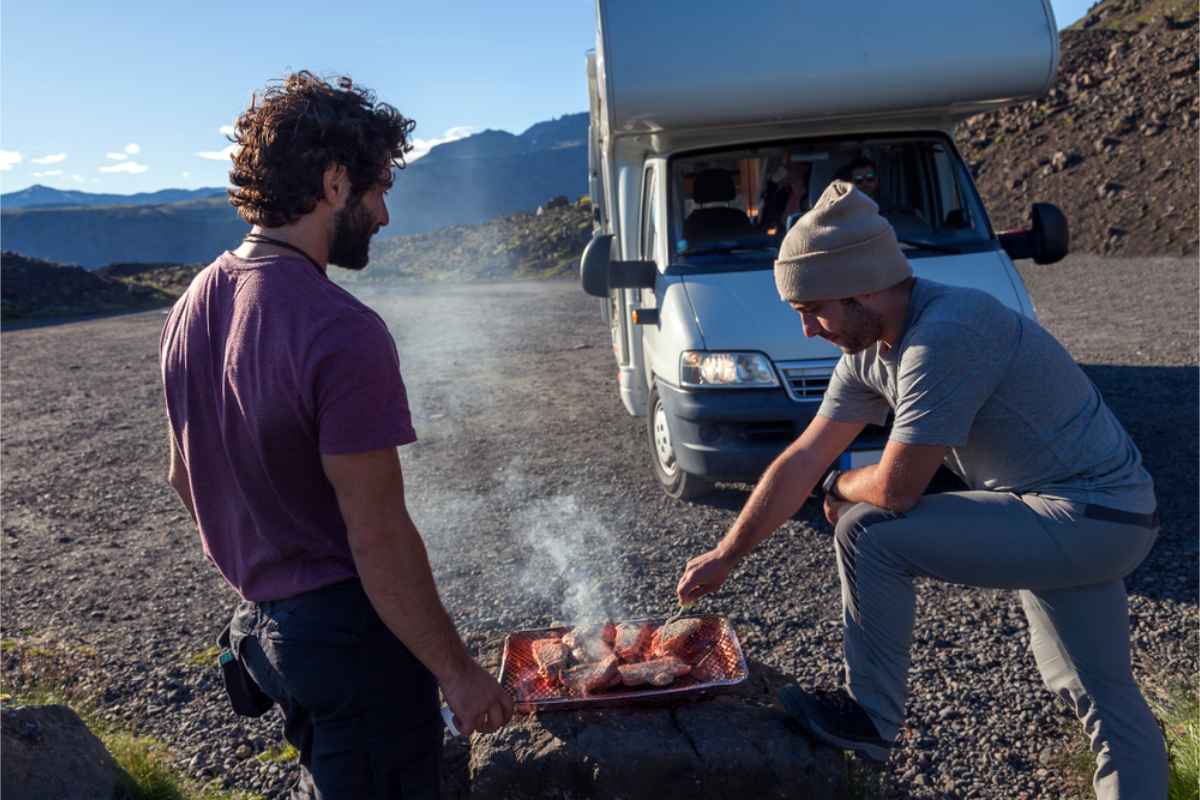 Campers grilling some meat by their RV