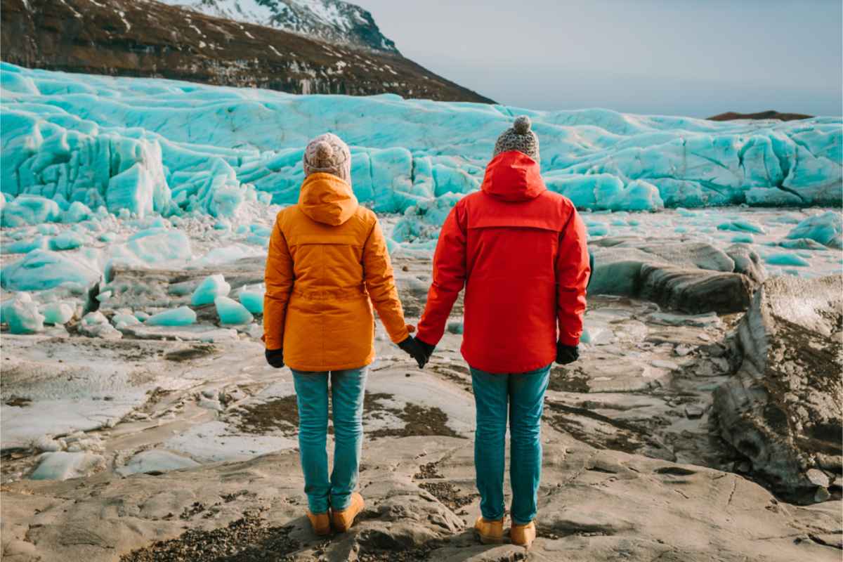 Two tourists wearing thick jackets in the winter in Iceland