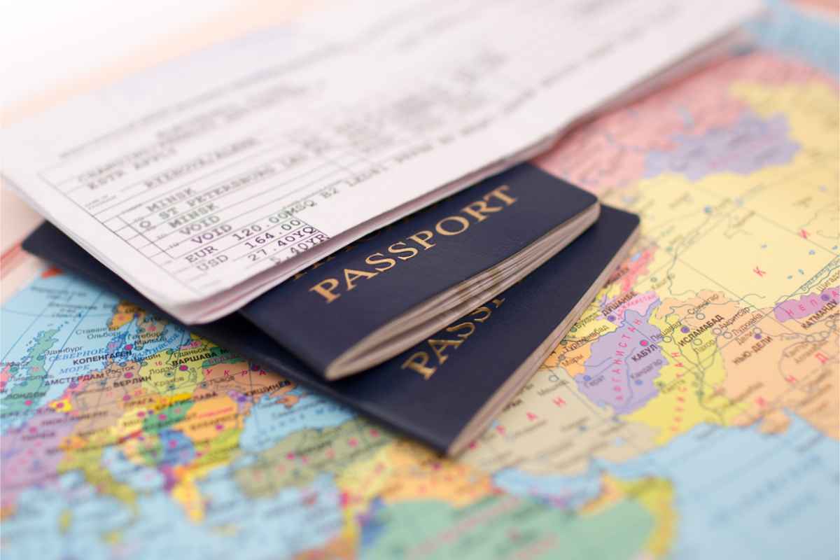 Passport and planet ticket on top of a map