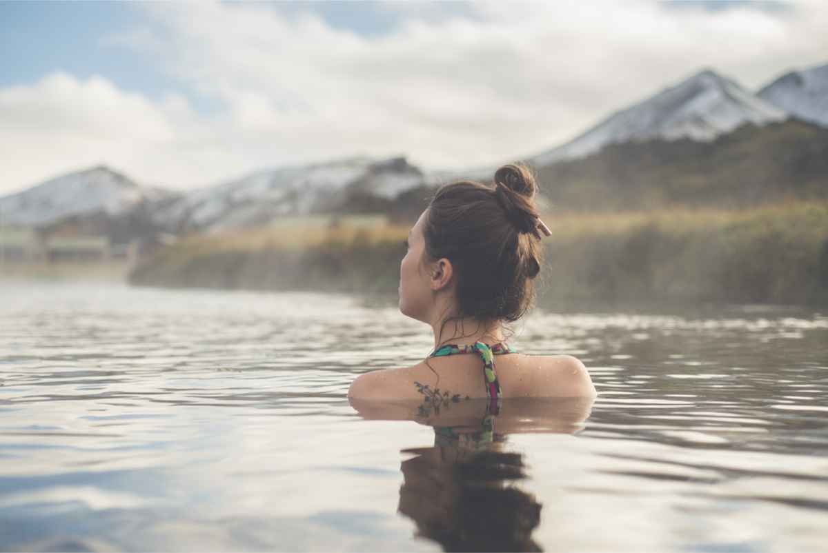 Tourist enjoying the hot springs waters in Landmannalaugar