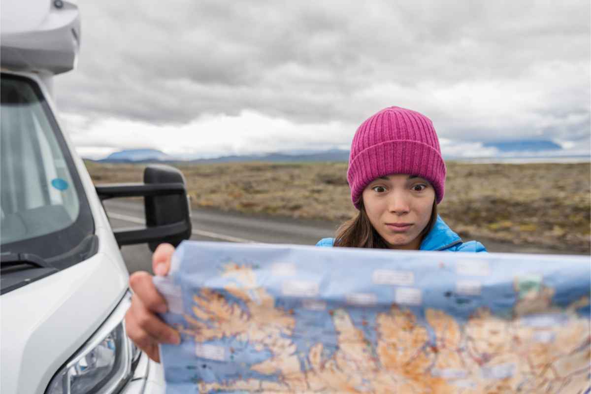 Tourist watching a map of Iceland, looking completely lost 