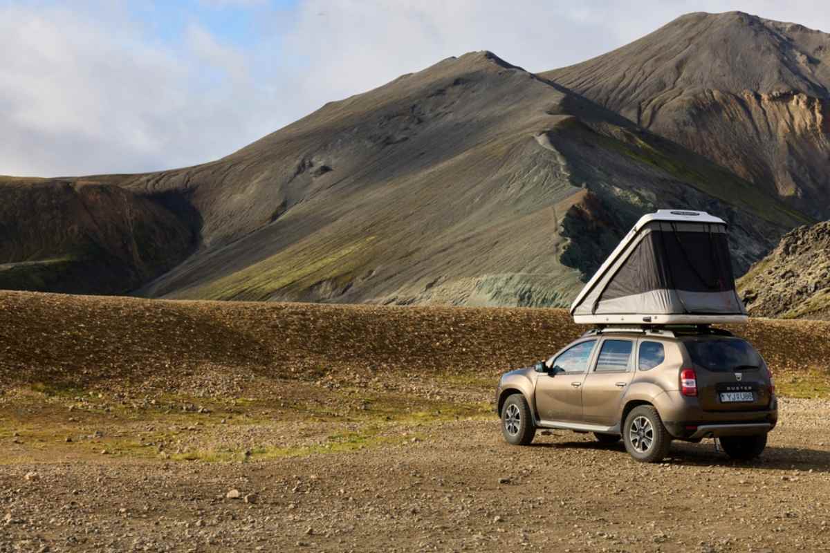 A Dacia Duster rooftop tent vehicle remains parked on what looks like the F-roads of Iceland.