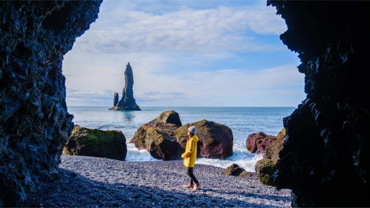 Tourist enjoying Reynisfjara black sand beach