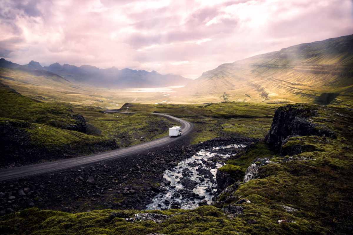 Motorhome driving through a volcanic landscape in Iceland