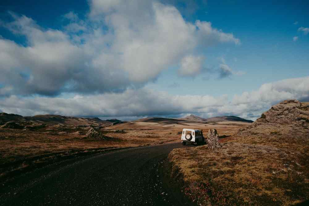 Icelandic Highlands Campervan parked on a remote volcanic road in the Icelandic Highlands.