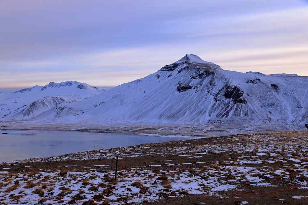 Iceland during winter Snow-covered mountains and coastline in Iceland during winter.