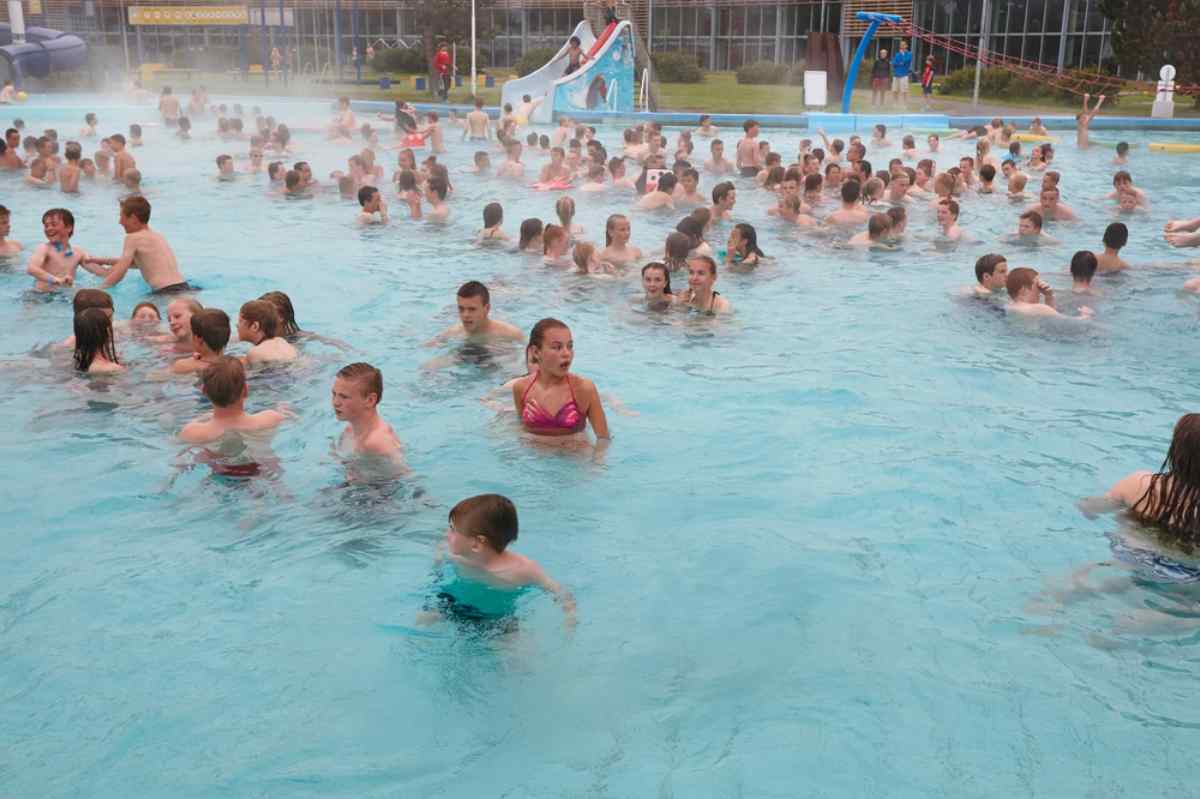 Laugardalslaug Pool Crowded Reykjavík geothermal swimming pool with steam.