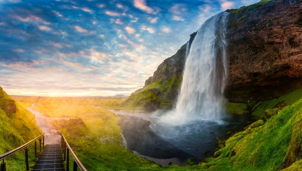 Midnight sun light Midnight sun light reflecting on a beautiful waterfall in Iceland