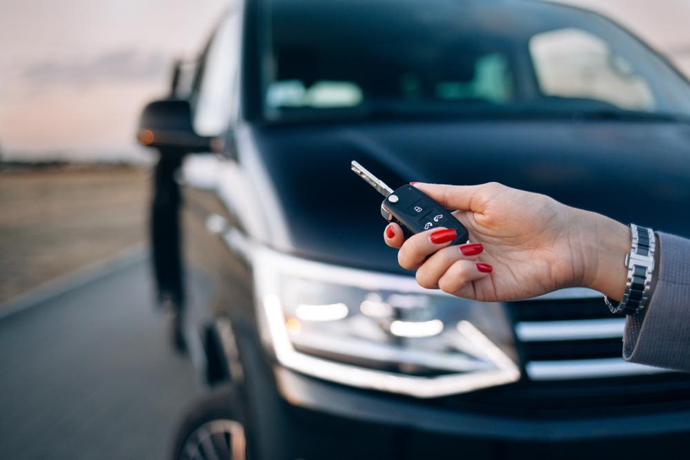 Woman holding a key for her rental vehicle